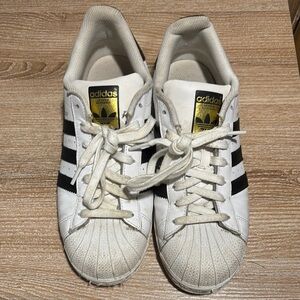 Adidas White Sneakers with Black Stripes and Gold Logo